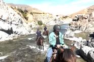 Crossing the river atop a horse 