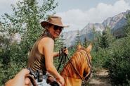 Girl- rider atop a horse 