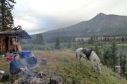 Tourists cooking dinner at the campfire 