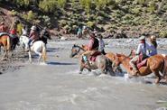 Horseback riding crossing the river