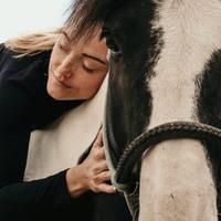 Woman hugging a horse 