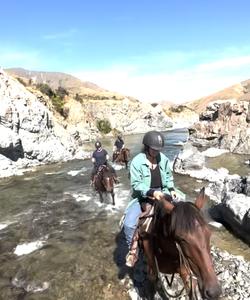 Crossing the river atop a horse 