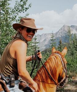 Girl- rider atop a horse 