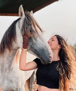 With a horse 