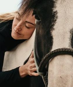 Woman hugging a horse 