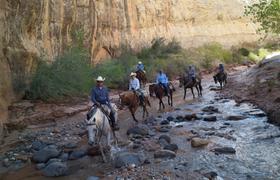 Crossing the river atop horses 