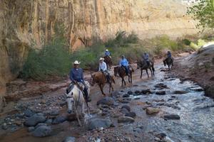 Crossing the river atop horses 