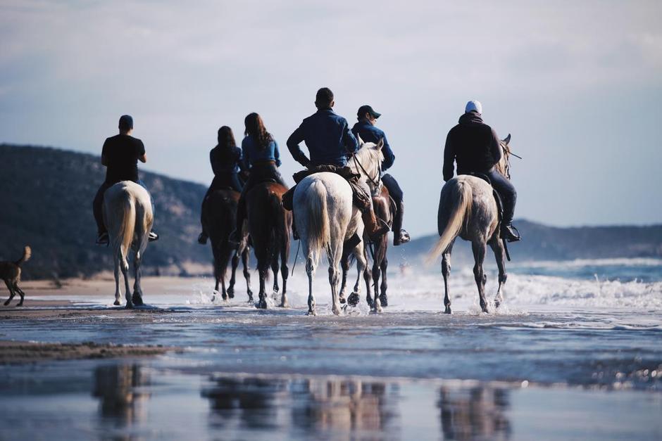 A group of horse riders on a Turkish beach